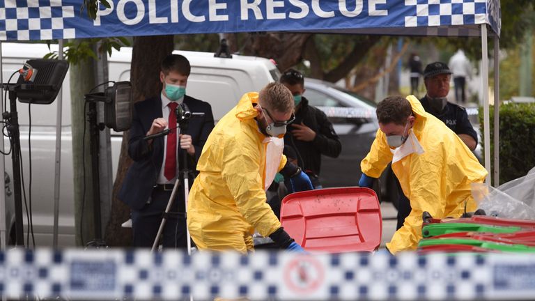 Police search for evidence at a block of flats in the Sydney suburb of Lakemba on July 31, 2017, after counter-terrorism raids across the city on the weekend. Four men accused of plotting to bring down a plane planned to use poisonous gas or a crude bomb disguised as a meat mincer, reports said, with Australian officials calling preparations &#39;advanced&#39;. The men -- reportedly two Lebanese-Australian fathers and their sons -- were arrested in raids across Sydney on Saturday evening. / AFP PHOTO / 