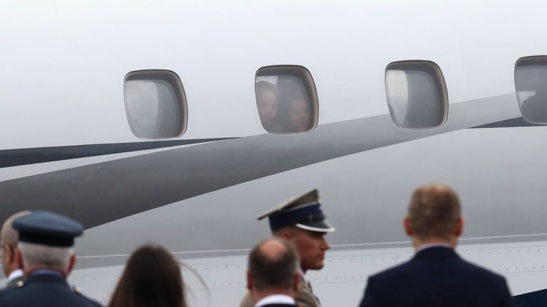 Prince George and Princess Charlotte peer out of the window as they land in Warsaw
