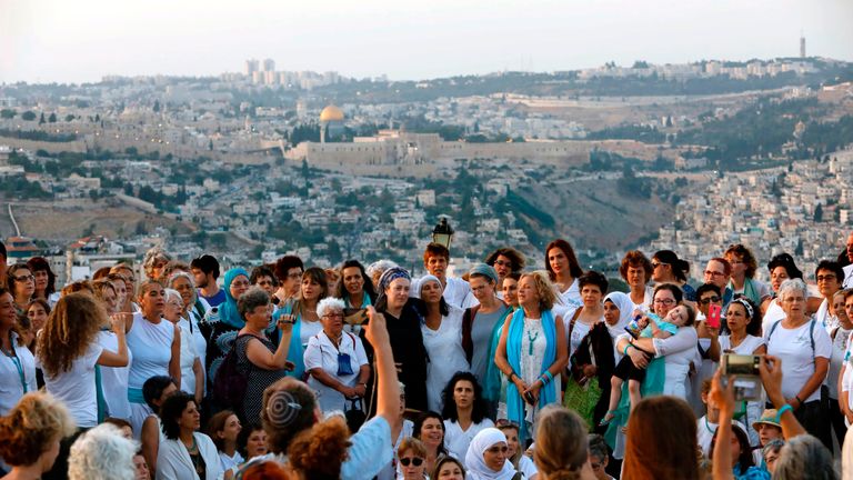 Members of Women Wage Peace gather near the Old City to call for dialogue