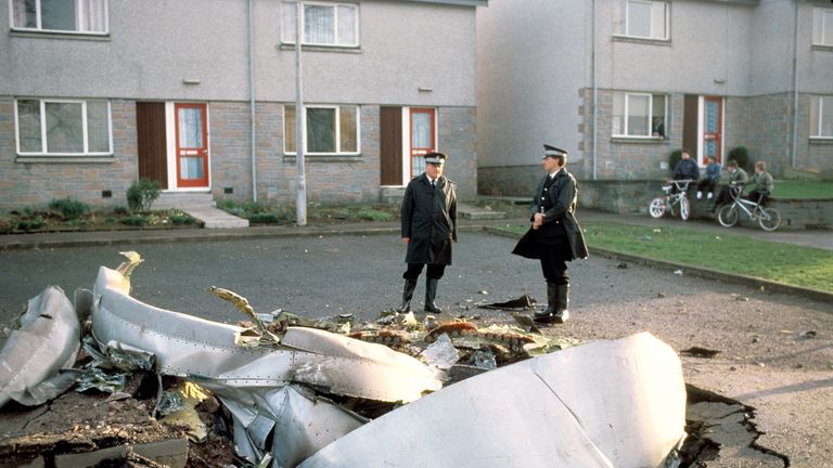 Police officers stand among debris left in the Scottish town of Lockerbie 