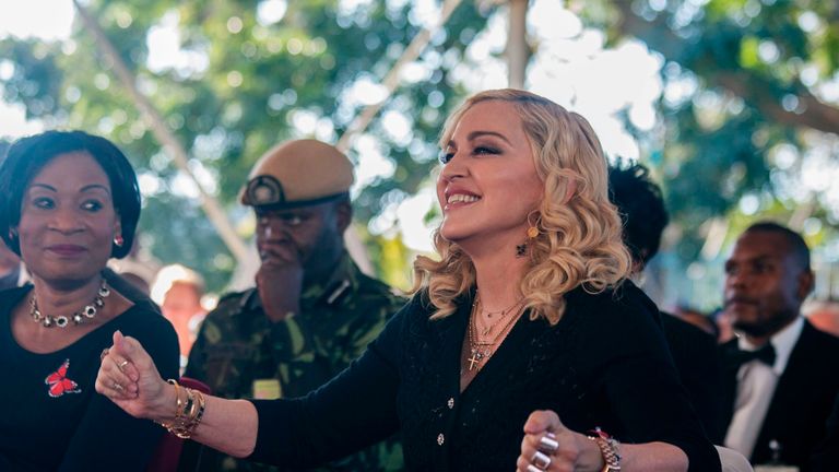 US pop star Madonna dances as Malawi&#39;s first lady Gertrude Mutharika (L) looks on during the opening ceremony of the Mercy James Children&#39;s Hospital at Queen Elizabeth Central Hospital in Blantyre, Malawi, on July 11, 2017. Madonna on July 11 took her four adopted Malawian children back to their home country for the opening of a paediatric hospital wing that her charity has built. / AFP PHOTO / AMOS GUMULIRA (Photo credit should read AMOS GUMULIRA/AFP/Getty Images)

