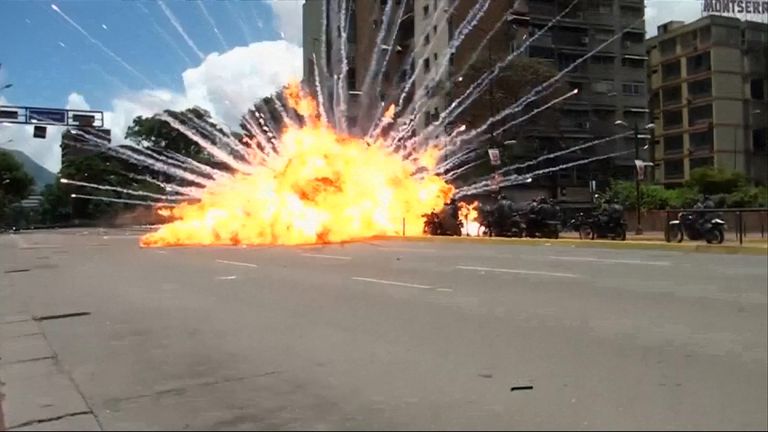  An explosion injures a group of police officers during a protest in Caracas, leaving eight motorbikes smouldering on a main avenue 