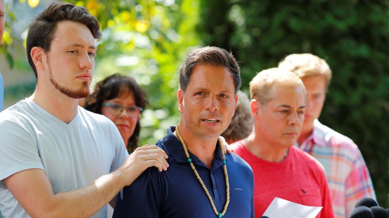 Don Damond is comforted by his son Zach Damond as he speaks to the media about his fiance, Justine Damond who was fatally shot by Minneapolis police in Minneapolis