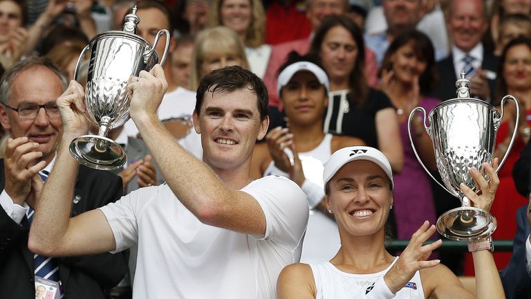 Britain's Jamie Murray (L) and Switzerland's Martina Hingis hold their winners trophies after beating Finland's Henri Kontinen and Britian's Heather Watson