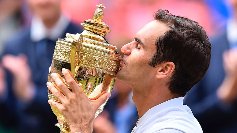 Switzerland's Roger Federer kisses the winner's trophy after beating Croatia's Marin Cilic in their men's singles final match