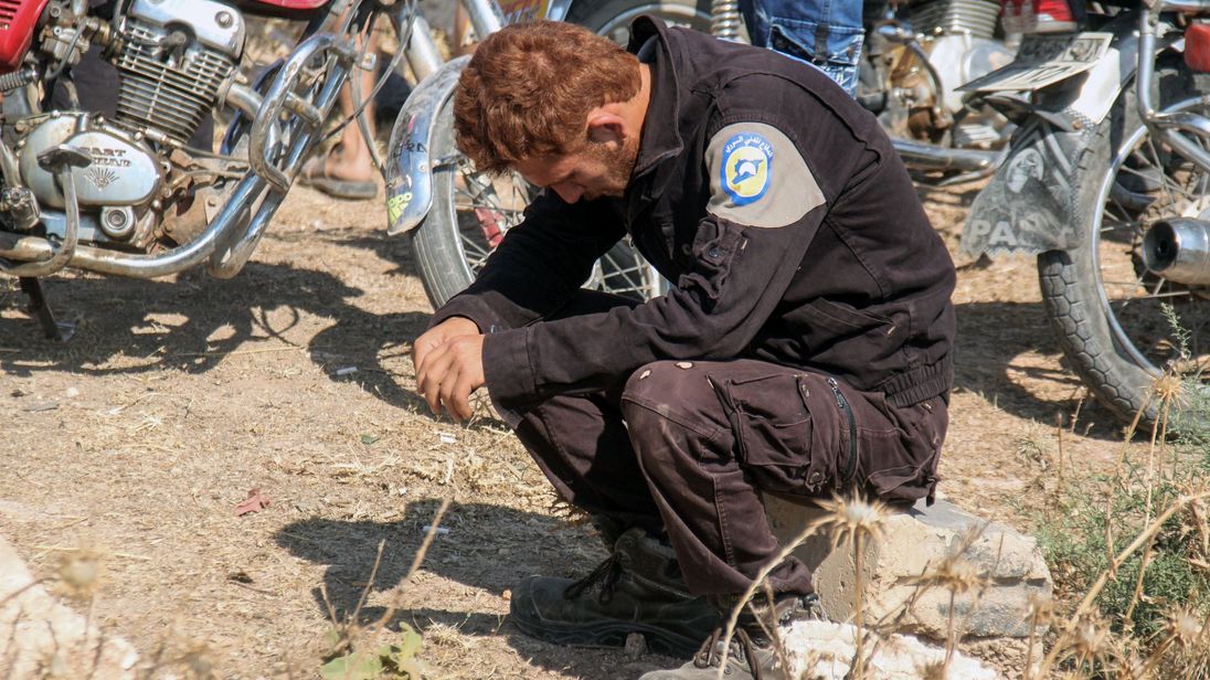 A member of the Syrian civil defence mourns his fellow comrades