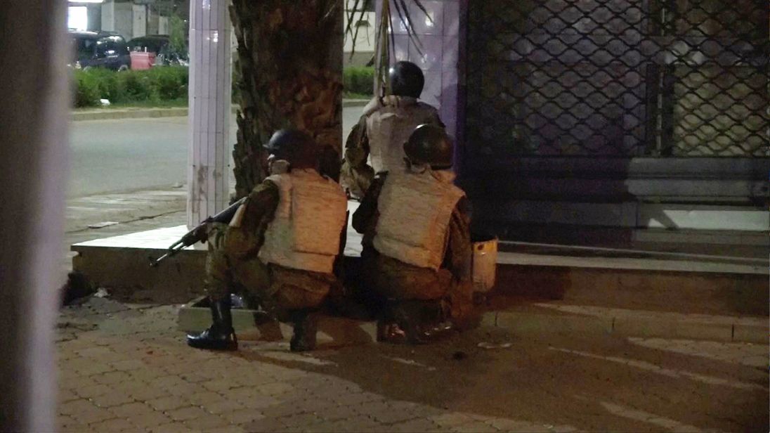Soldiers surround a restaurant following an attack by gunmen on the restaurant in Ouagadougou, Burkina Faso, in this still frame taken from video August 13, 2017
