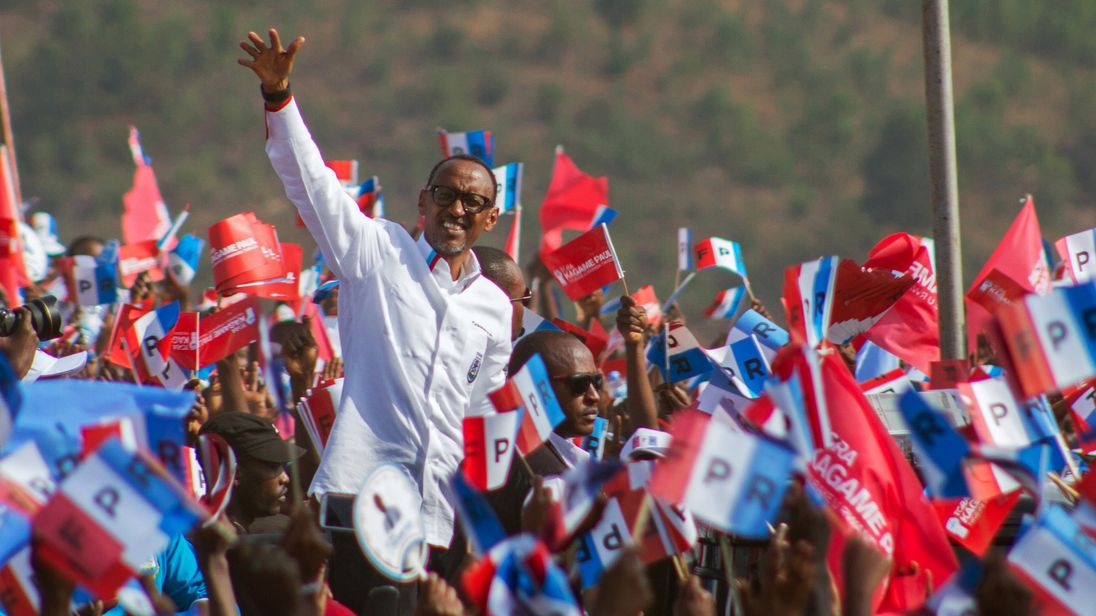 Paul Kagame waves to his supporters during his final campaign rally in Kigali, Rwanda