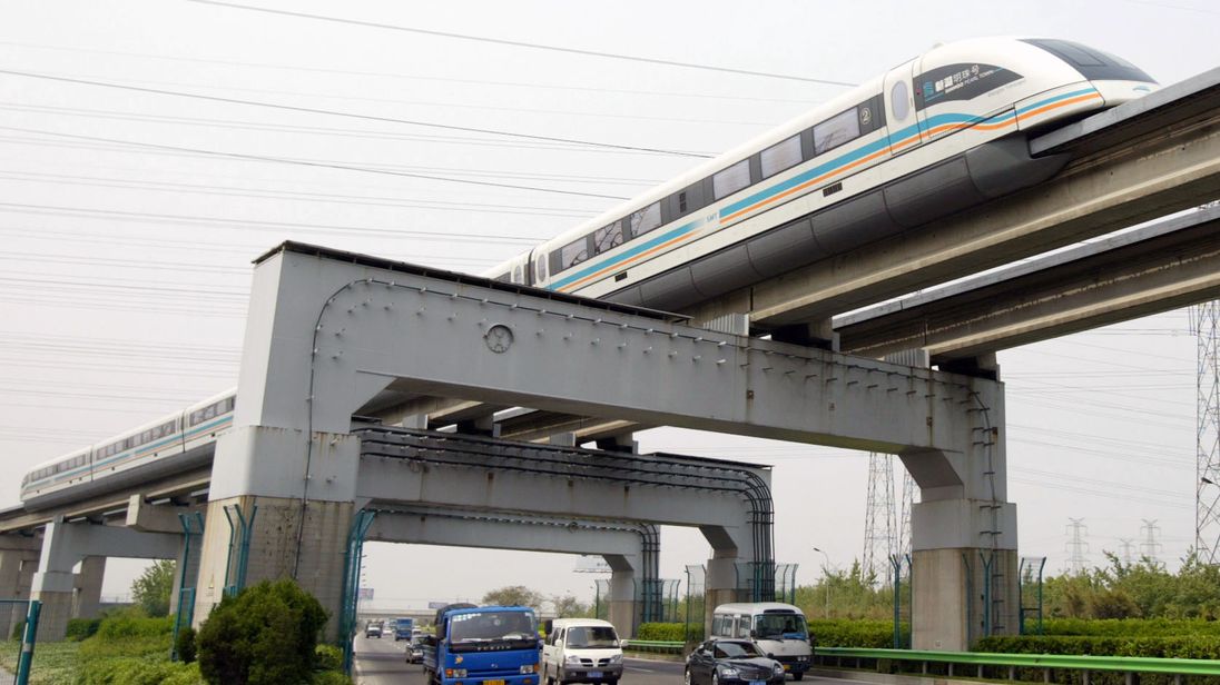 A maglev train passes above traffic in Shanghai, China
