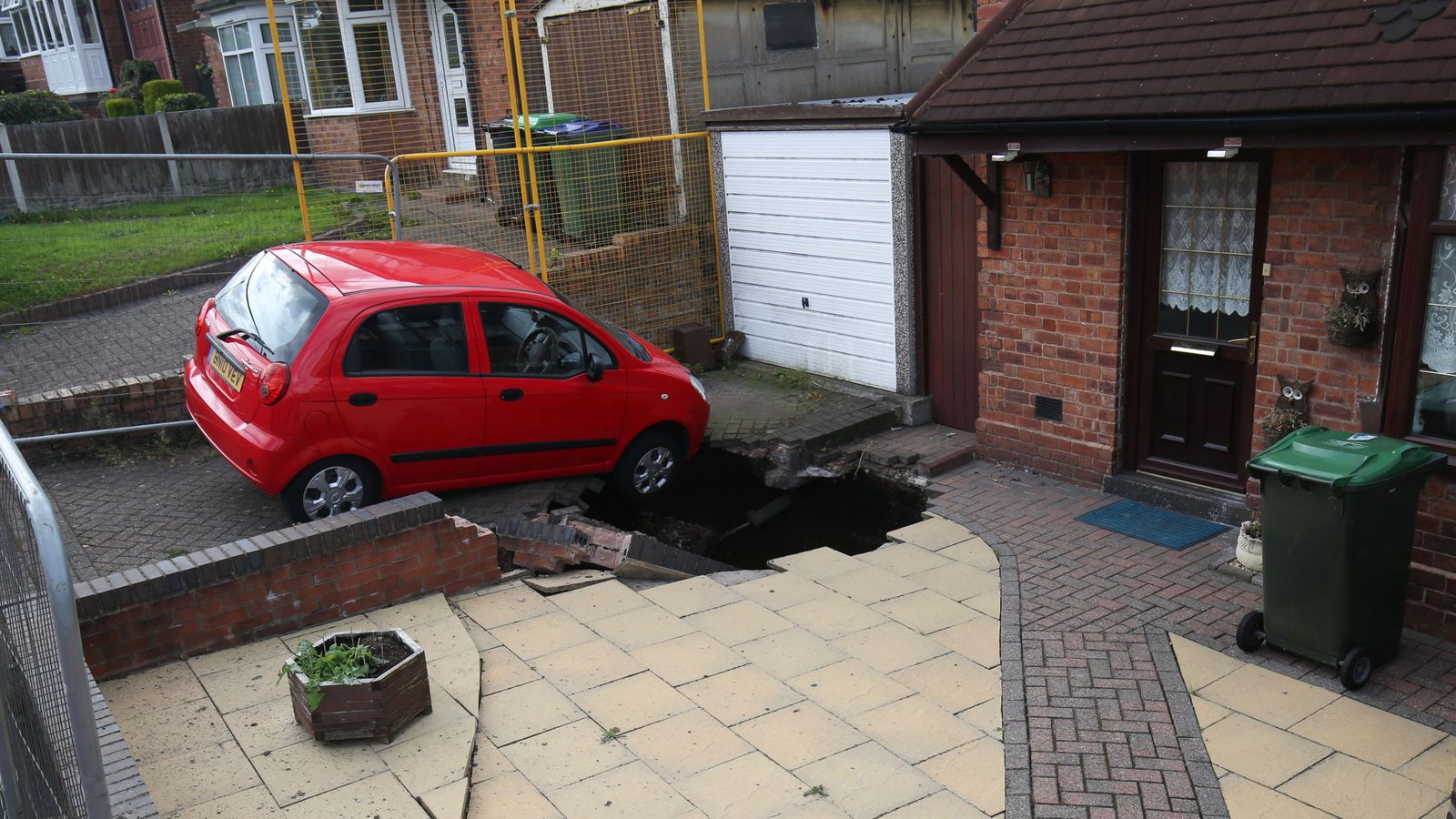 Sinkhole continues to grow after consuming front wall and driveway UK