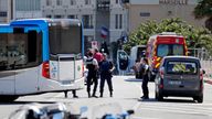 French police secure the area in Marseille, where one person was killed and another injured after a car crashed into two bus shelters