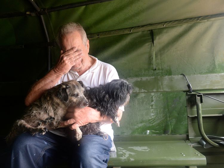 A man reacts after he was rescued in Cypress Creek, Houston