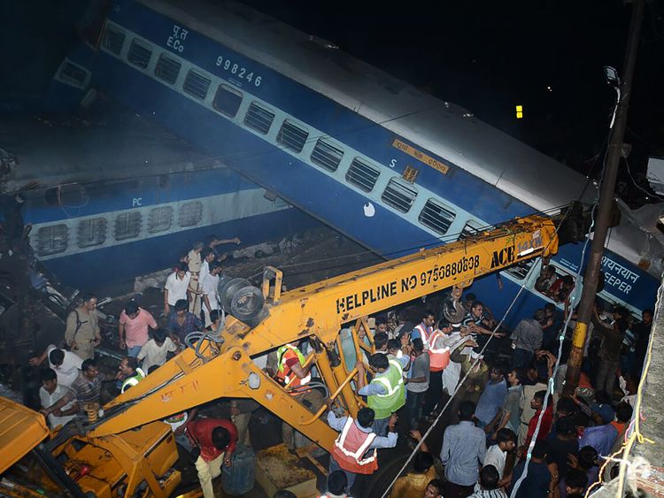 Emergency workers look for survivors on the wreckage of a train carriage after an express train derailed near the town of Khatauli in the Indian state of Uttar Pradesh on August 19, 2017