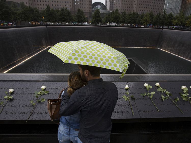 A couple stand under an umbrella at the national 9/11 memorial in Manhattan. File pic