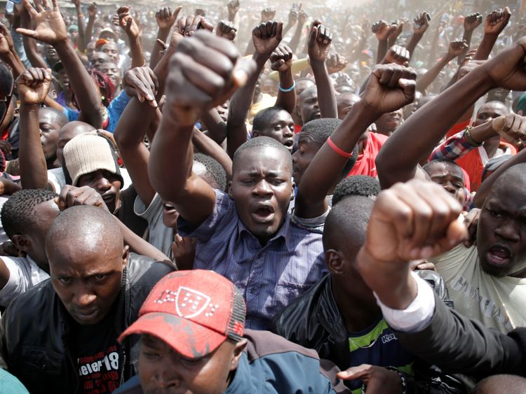Supporters of Raila Odinga shout during a rally in Nairobi's Kibera slum