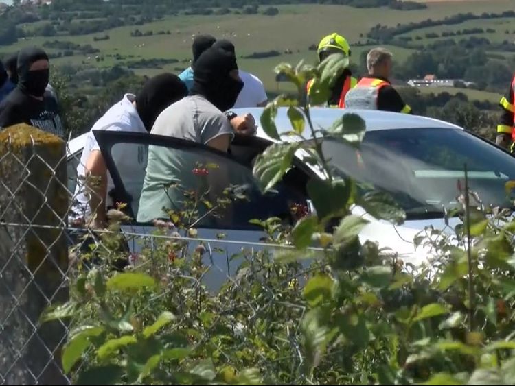 Police in balaclavas at the scene of arrest