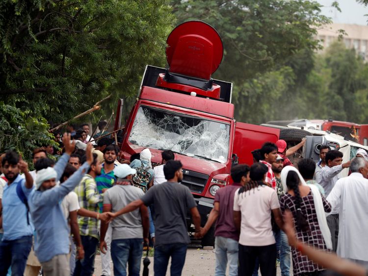 Rioters smash television trucks during violence in Panchkula, India,