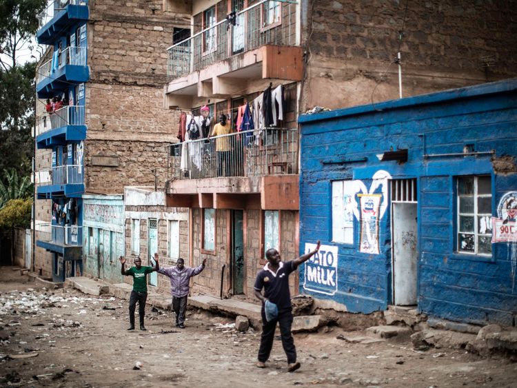 Residents plead with Kenyan security forces as they conduct an operation in Mathare