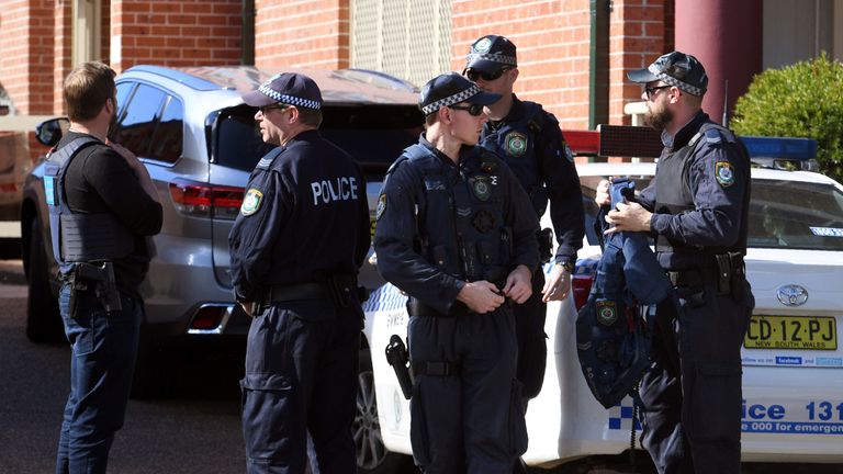 Police emerge from a block of flats in the Sydney suburb of Lakemba on August 1, 2017, after counter-terrorism raids across the city at the weekend