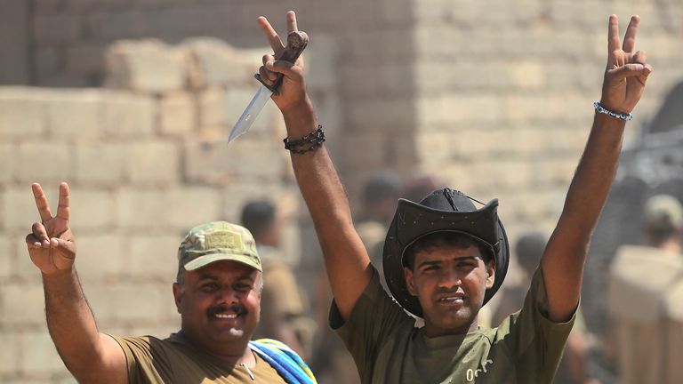 Iraqi forces flash the victory sign ahead of the advance towards al Ayadieh