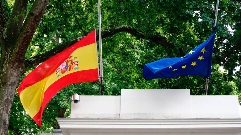 A Spanish and an EU flag fly at halfmast above the Spanish Embassy in London 