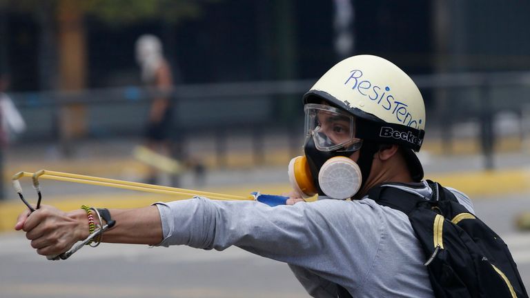 A demonstrator uses a slingshot