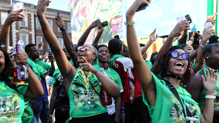 Young revellers take selfies during the children's parade at the Notting Hill Carnival
