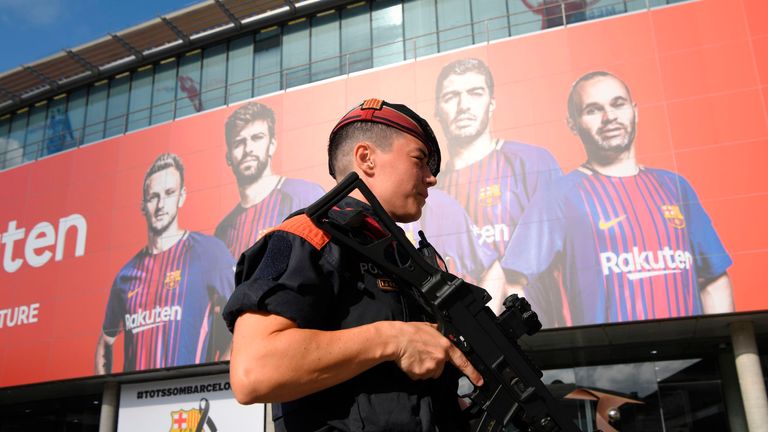 An armed Catalan policeman outside the Camp Nou stadium ahead of the Barcelona vs Real Betis match