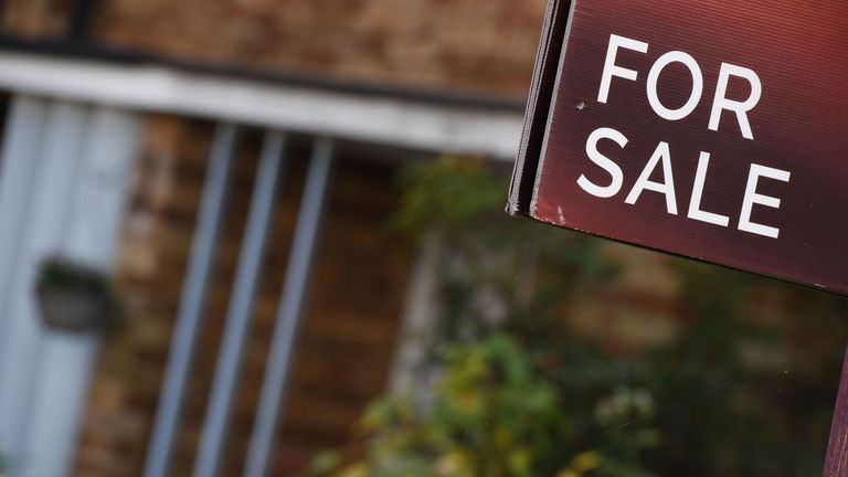 An estate agent&#39;s &#39;for sale&#39; board stands outside a residential building in London 