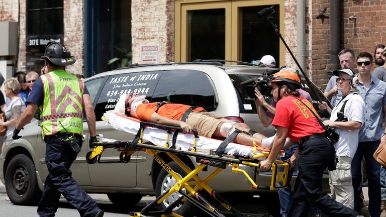 Rescue workers transport a victim who was injured when a car drove through a group of counter protestors at the "Unite the Right" rally Charlottesville, Virginia