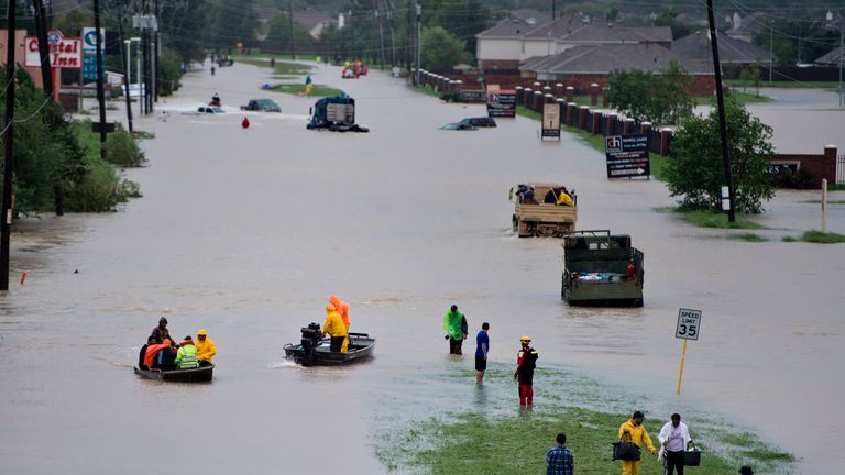 Volunteer rescuers evacuate people from a flooded residential area during the aftermath of Hurricane Harvey on August 29, 2017 in Houston, Texas. Floodwaters have breached a levee south of the city of Houston, officials said Tuesday, urging residents to leave the area immediately. / AFP PHOTO / Brendan Smialowski (Photo credit should read BRENDAN SMIALOWSKI/AFP/Getty Images)
