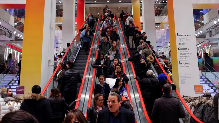 Shoppers ride escalators during Black Friday sales at the Uniqlo Fifth Avenue store in Manhattan, New York, U.S., November 25, 2016. REUTERS/Andrew Kelly 