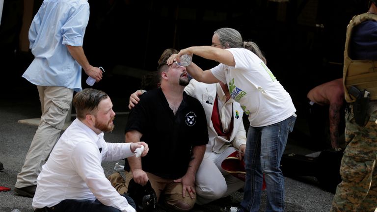 Members of white nationalist protesters receive first-aid during a clash against a group of counter-protesters in Charlottesville, Virginia