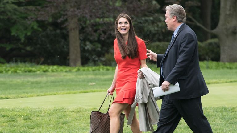 Hope Hicks and Steve Bannon walk across the White House lawn to Marine One