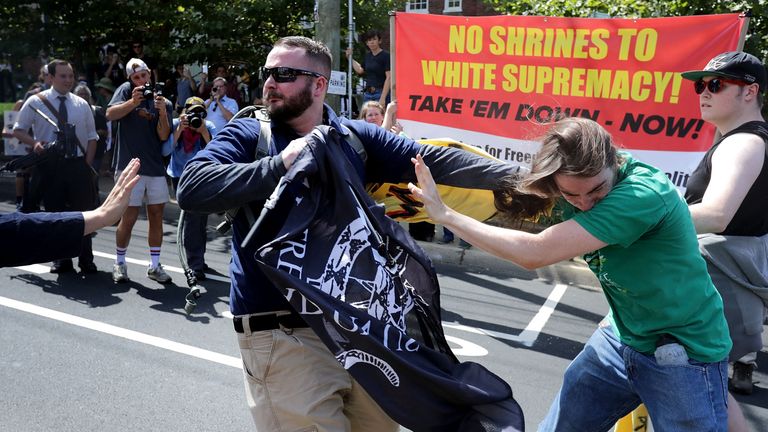 White nationalists, neo-Nazis and members of the 'alt-right' clash with counter-protesters in the street after the 'Unite the Right' rally was declared a unlawful gathering by Virginia State Police August 12