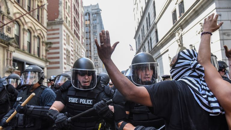 Boston Police officers react as a crowd of counter protesters clashes with them outside of the Boston...