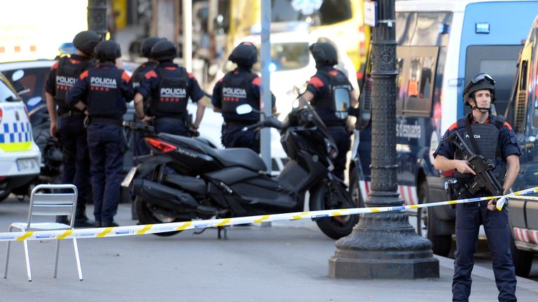 Armed police stand guard after the Barcelona attack