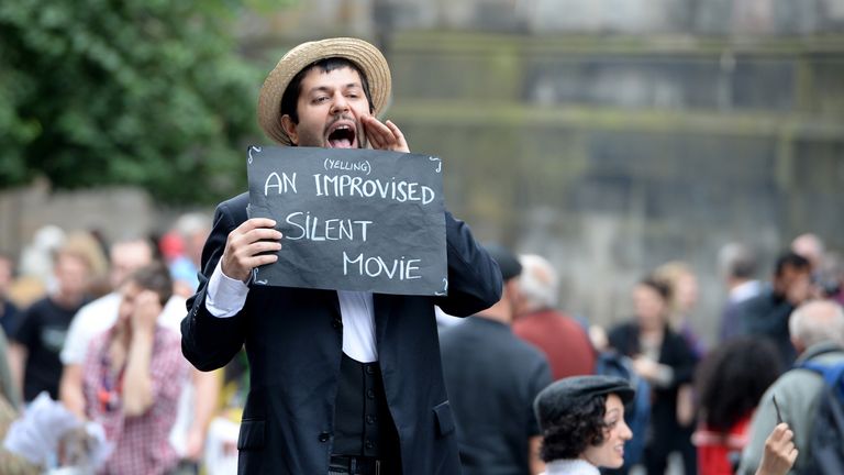 EDINBURGH, SCOTLAND - AUGUST 23: Edinburgh Festival Fringe entertainers perform on the Royal Mile as the festival enters its final weekend on August 23, 2013 in Edinburgh, Scotland. The largest performing arts festival in the world has been running for the past three weeks and has enjoyed an increase in venues and visitors compared with previous years. (Photo by Jeff J Mitchell/Getty Images)

