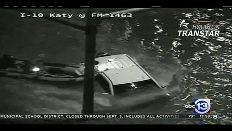 CCTV films a man being rescued from his his almost completely submerged car