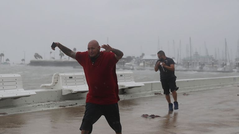 Two men braved the winds just before the hurricane made landfall