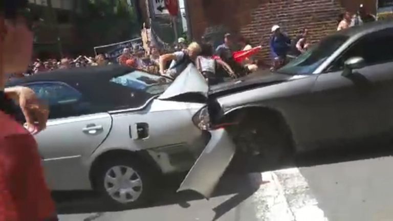 Car sends counter-protesters flying