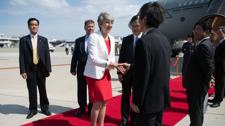 Prime Minister Theresa May is greeted by dignitaries as she arrives in Japan