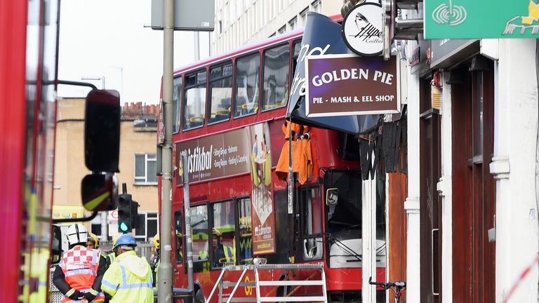 Emergency services at the scene in southwest London after a bus hit a shop