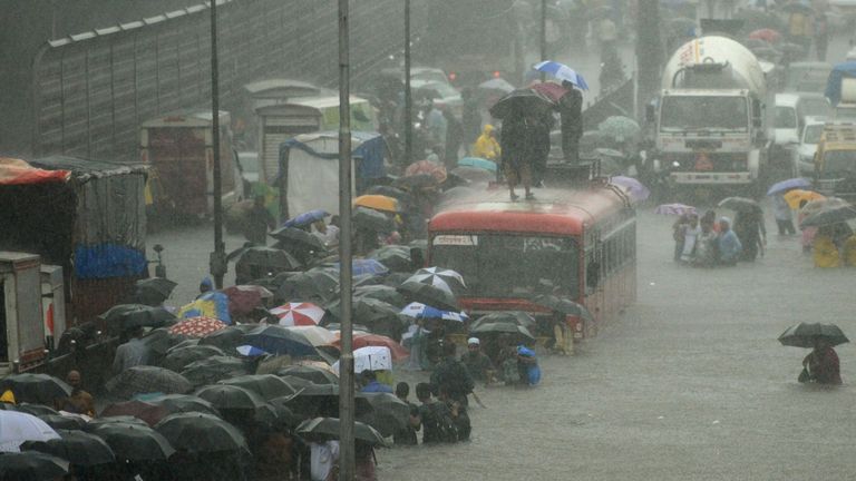 Wading through a flooded street in Mumbai