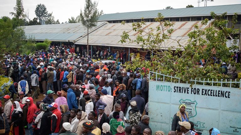 People wait in line to cast their ballot in the general elections at a polling station in Eldoret, Kenya