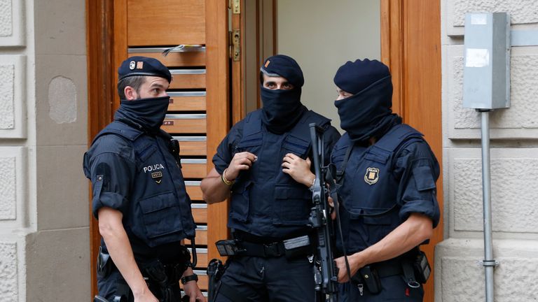 Police officers outside a house in Ripoll during a search linked to the Barcelona attack