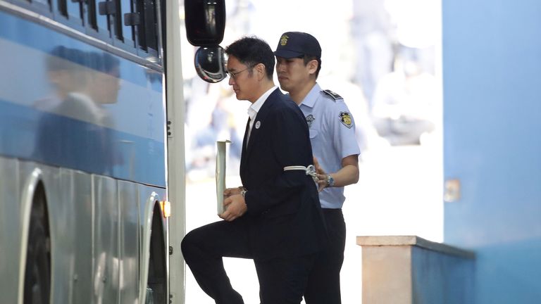 Lee Jae-yong is taken away to begin his prison sentence