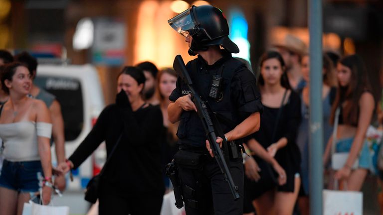 A policeman stands guard after a van deliberately drove at a crowd in a busy tourist district