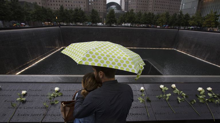 A couple stand under an umbrella at the national 9/11 memorial in Manhattan. File pic