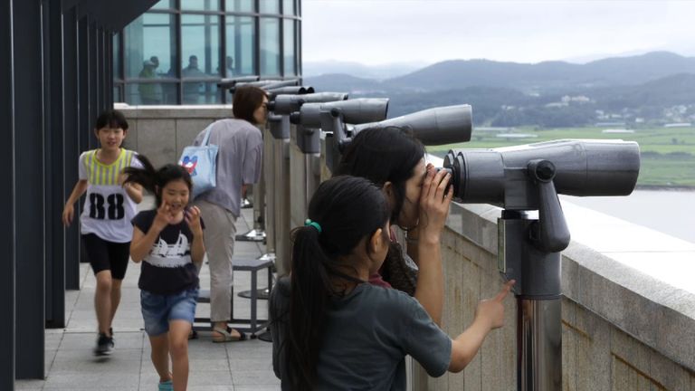 Visitors observe North Korea from the southern side of the Imjin River